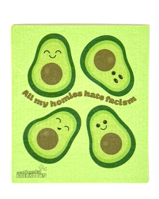 A square green dish towel with a ribbed texture, featuring four cartoon avocado faces and the text 'All my homies hate facism!' in brown script. The towel is photographed flat against a plain off-white background.