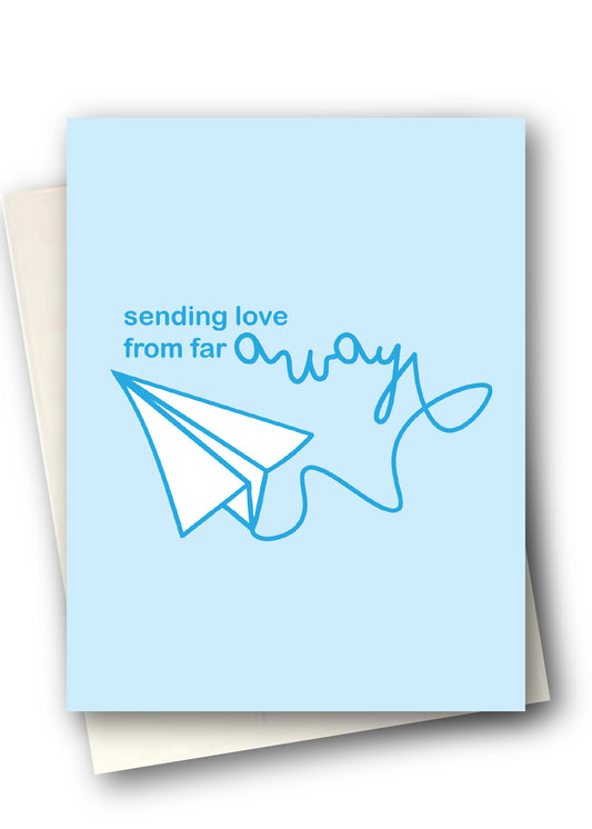 Greeting card with a paper airplane and text 'sending love from far away' on a light blue background.