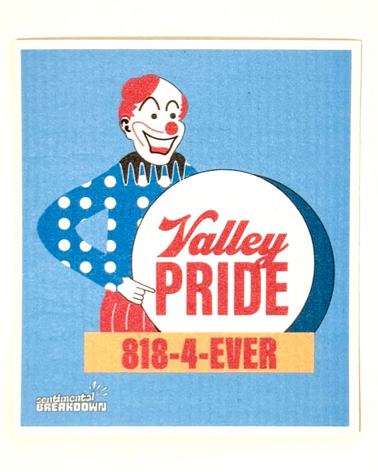 A vintage-style rectangular sign or card with a blue striped background, featuring a clown illustration and the text 'Valley PRIDE' and '818-4-EVER', photographed against a plain light wall.